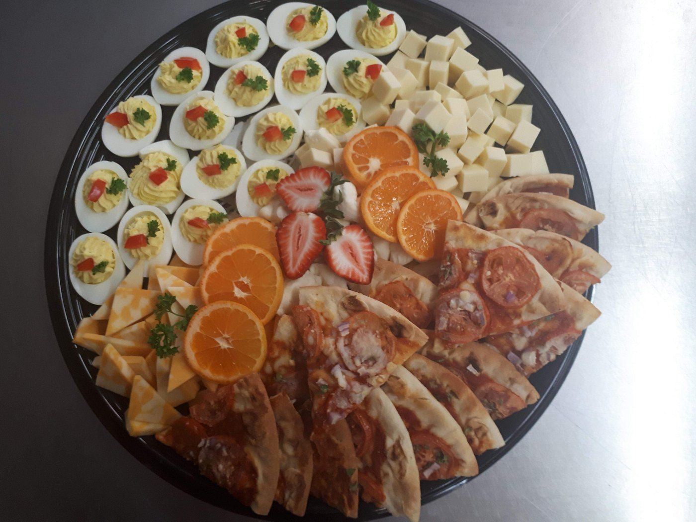 Cold buffet platter with deviled eggs and fruit