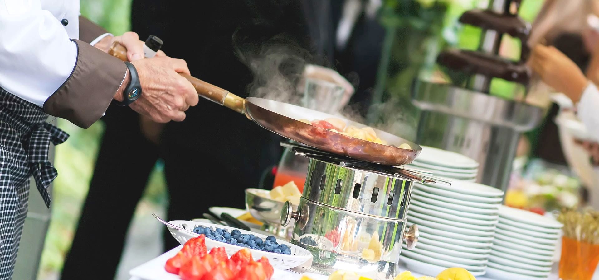 Catering service in Sherbrooke: a Réception 108 chef cooking in front of an event buffet